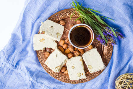 Halva dessert and black coffee on a trayの写真素材