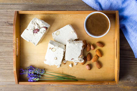 Halva dessert and black coffee on a trayの写真素材