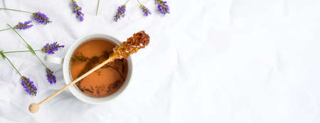 Lavender tea with fresh flowers and brown sugar stickの写真素材