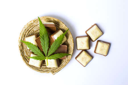 Marijuana leaf on top of chocolate pieces isolatedの写真素材