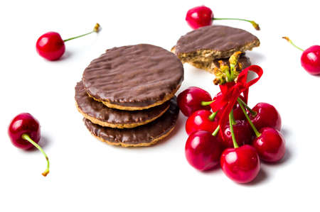 Cherry biscuits and fruits isolated on whiteの写真素材