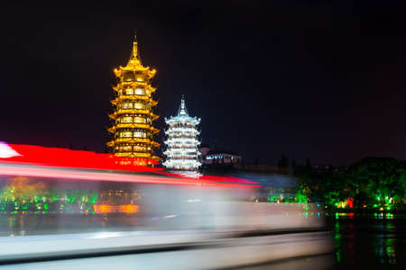 Boat passing buy Guilin twin towers in Guangxi, China. Long exposureのeditorial素材