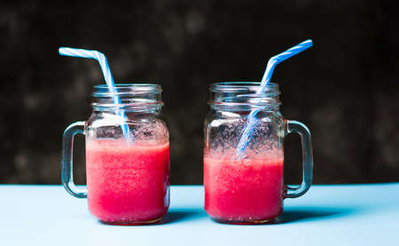 Two jars of healthy watermelon smoothie. Summer refreshmentの写真素材