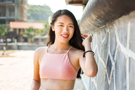 Beautiful girl in swimsuit on the beachの写真素材