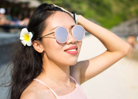 Beautiful girl on the beach wearing pink accessories