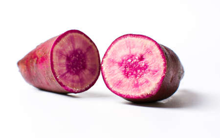 Raw purple potato isolated on white backgroundの写真素材