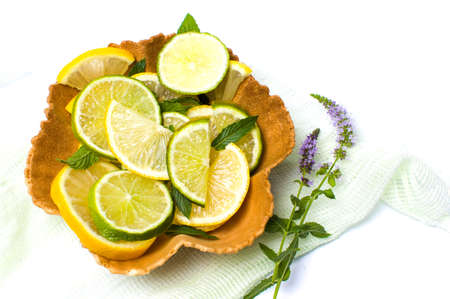 Lemon and green lime slices with mint leavesの写真素材