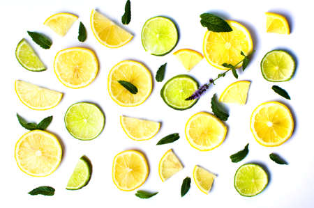 Lemon and lime slices with mint leaves on white backgroundの写真素材