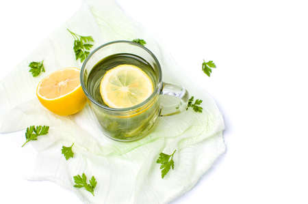 Parsley tea with lemon and lime slices on whiteの写真素材