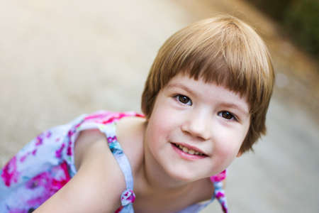 Restless three years old girl having fun outdoorsの写真素材