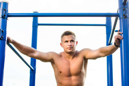 Masculine man in a street workout playground