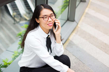 Business woman having a phone call outsideの写真素材