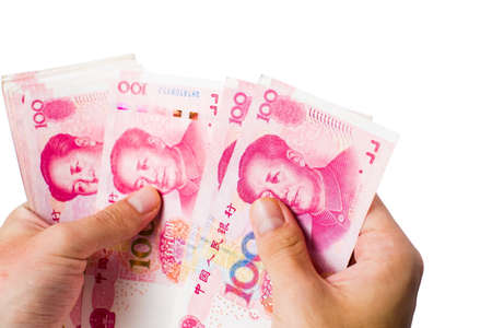 Female hands counting money in Chinese yuan isolatedの写真素材