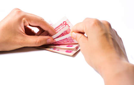 Female hands counting money in Chinese yuan isolatedの写真素材