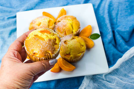 Homemade apricot muffins with fruit in a bowlの写真素材