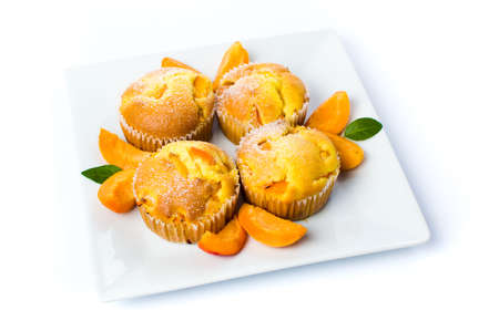 Homemade apricot muffins with fruit in a bowlの写真素材
