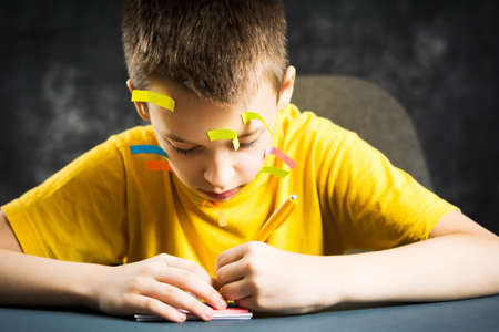 Teenage boy with his face covered in note stickers