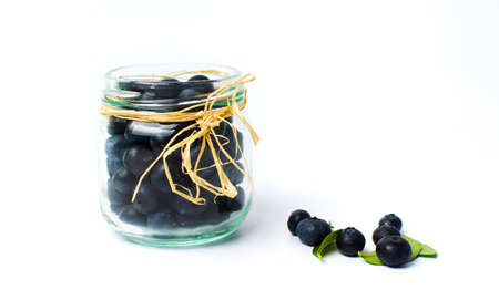 Blueberry fruits in a glass jar isolatedの写真素材