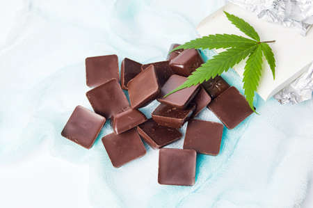 Marijuana leaf with chocolate cubes on textile backgroundの写真素材
