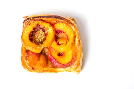 Homemade peach fruit pie slice on white backgroundの写真素材