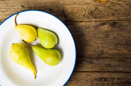 Green pears on a rustic wooden backgroundの写真素材