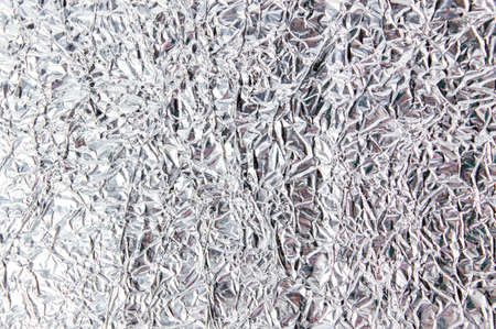 Aluminum foil shiny wrinkled background pattern texture