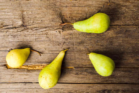 Green pears on a rustic wooden backgroundの写真素材