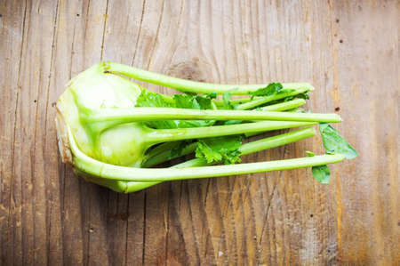 Kohlrabi a healthy green vegetable on a rustic boardの写真素材