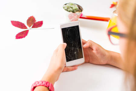 Girl using a phone with broken screen