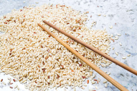 Yellow rice and wooden chopsticksの写真素材