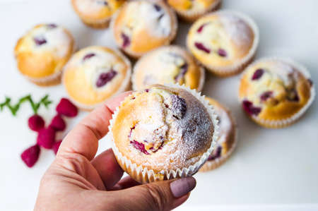 Home made raspberry muffins in paper holdersの写真素材