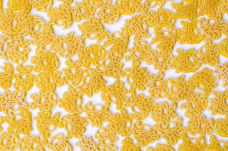 Golden raw pasta making a background patternの写真素材
