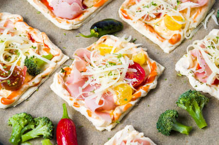 Homemade pizza sandwiches on a brown baking paperの写真素材