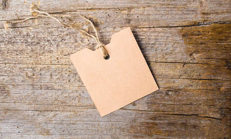 Empty label card on a rustic wooden backgroundの写真素材