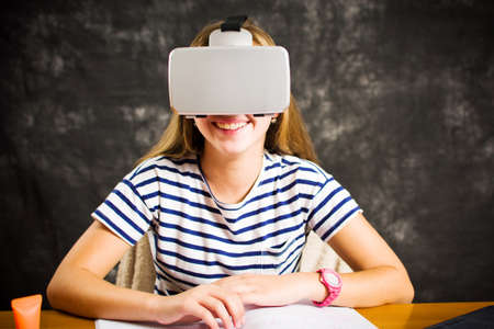 Teenage girl having fun with virtual reality glasses