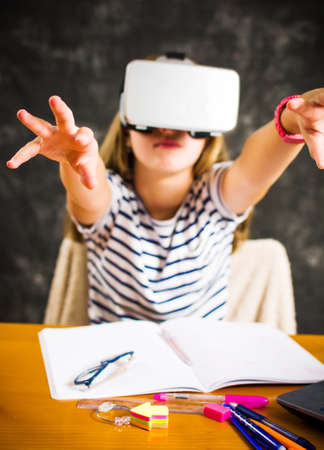 Teenage girl having fun with virtual reality glasses