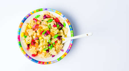 Shaped children pasta in colorful bowl tabletopの写真素材