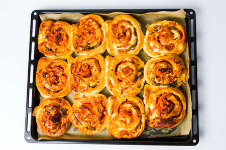 Rolled pizza pastry on baking paper top viewの写真素材