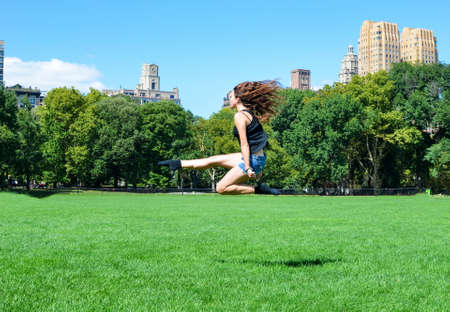 Girl jumping high in Central park, New Yorkの写真素材