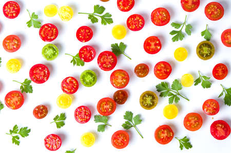 Sliced small cherry tomatoes and parsley background flat layの写真素材