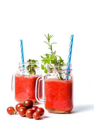 Homemade tomato smoothie in glass jars with parsleyの写真素材