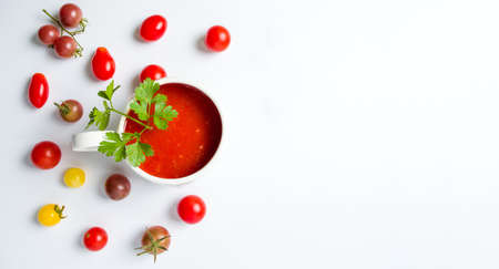Ketchup and small cherry tomatoes on white background isolated の写真素材
