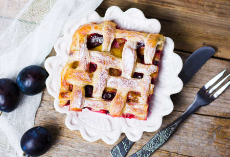 Sweet baked fruit pie with sugar on a trayの写真素材