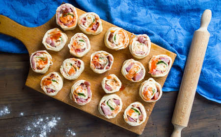 PIzza rolls pastry on a wooden cutting board