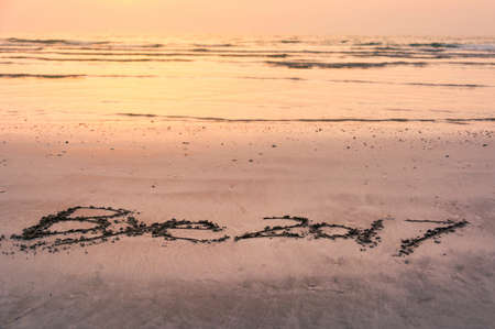 Bye 2017 note written in the beach sand with sunset view