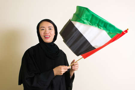 Muslim woman with the United Arab Emirates flag