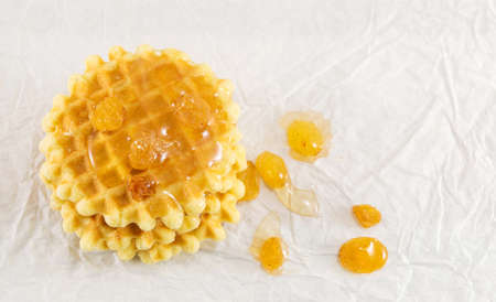 Baked golden waffle cookies and sweet honeyの写真素材