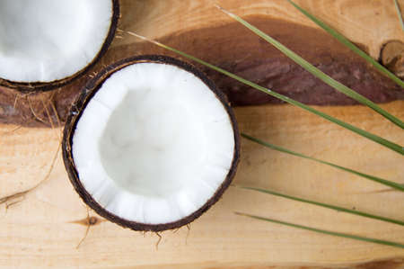 Open coconut fruit on a wooden table