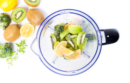 Kiwi and orange fruits in a blender for making a smoothieの写真素材