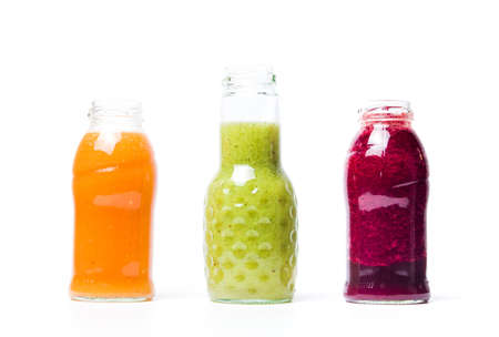Colorful smoothies with fruits isolated on whiteの写真素材